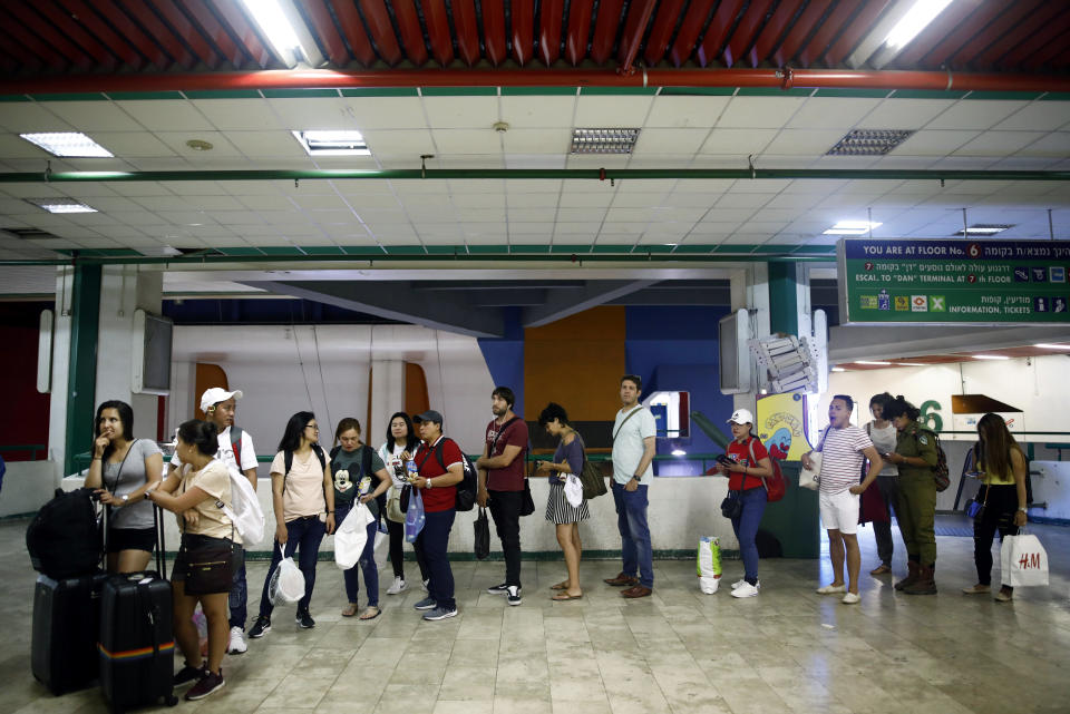 Passengers wait to board a bus at the Central Bus Station on May 25. (Photo: Corinna Kern/Reuters)