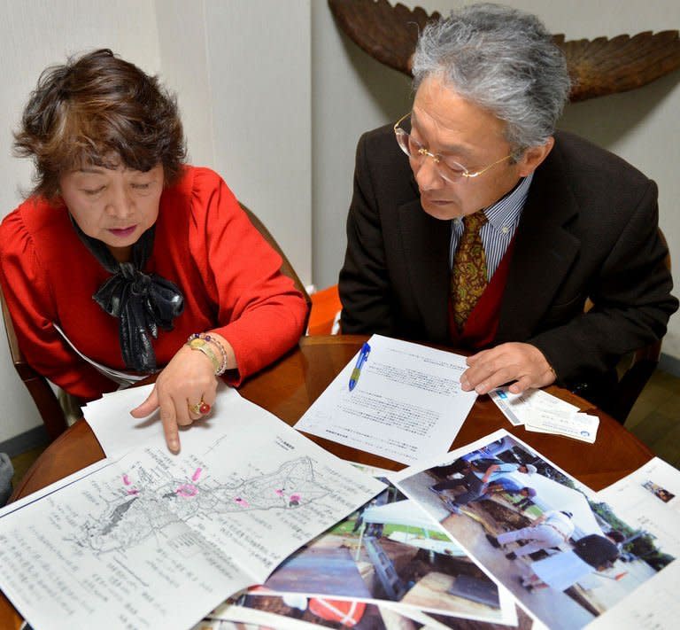 Heitaro Matsumoto (R) and Sumiko Naito, who have volunteered to repatriate fallen Japanese soldiers, are pictured in Tokyo on February 5, 2013. Some 2.4 million Japanese soldiers died overseas during the war. Nearly half of them still lie in a vast area somewhere between Russia and remote southern Pacific islands