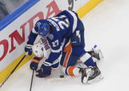 Tampa Bay Lightning's Ryan McDonagh (27) and New York Islanders' Derick Brassard (10) battle for the puck during second-period NHL Eastern Conference final playoff game action in Edmonton, Alberta, Monday, Sept. 7, 2020. (Jason Franson/The Canadian Press via AP)