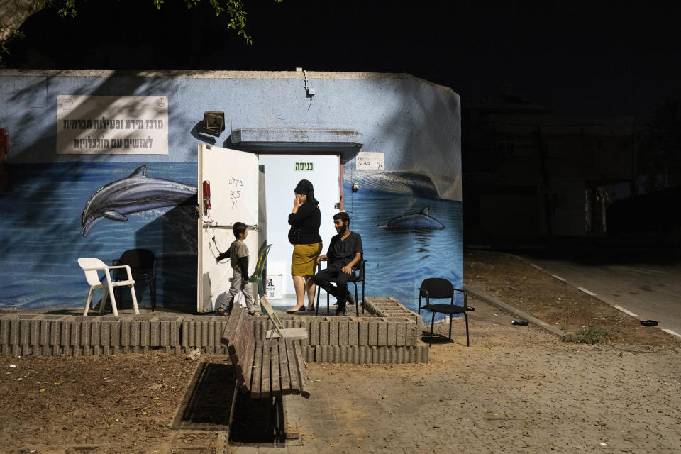 Residents gather outside a neighbourhood's bomb shelter in Ashkelon, Israel, Wednesday, Nov. 1, 2023. (AP Photo/Bernat Armangue)