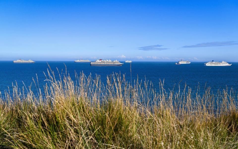 A number of cruise ships are anchored off the Dorset coast, where they have remained since last spring - Getty