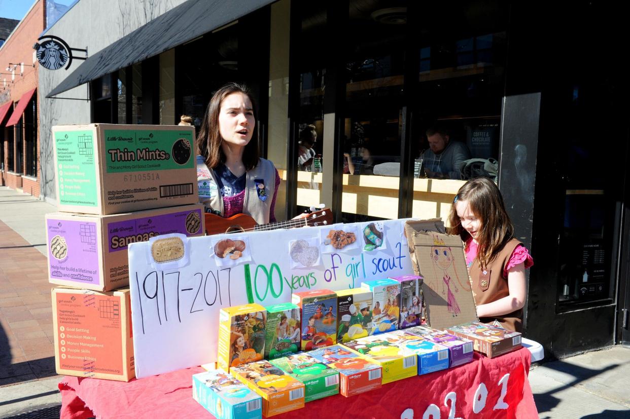 Two Girl Scouts Selling Boxes of Girl Scout Cookies Outside With a Table, Chicago