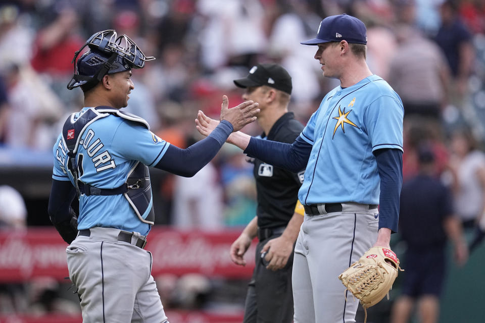 Tampa Bay Rays catcher Christian Bethancourt, left, and relief pitcher Pete Fairbanks, right, shake hands after they defeated the Cleveland Guardians in a baseball game Sunday, Sept. 3, 2023, in Cleveland. (AP Photo/Sue Ogrocki)