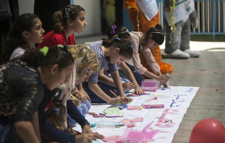 Palestinian youth draw during a summer camp at a United Nations Relief and Works Agency (UNRWA) school on July 23, 2016 in Gaza City