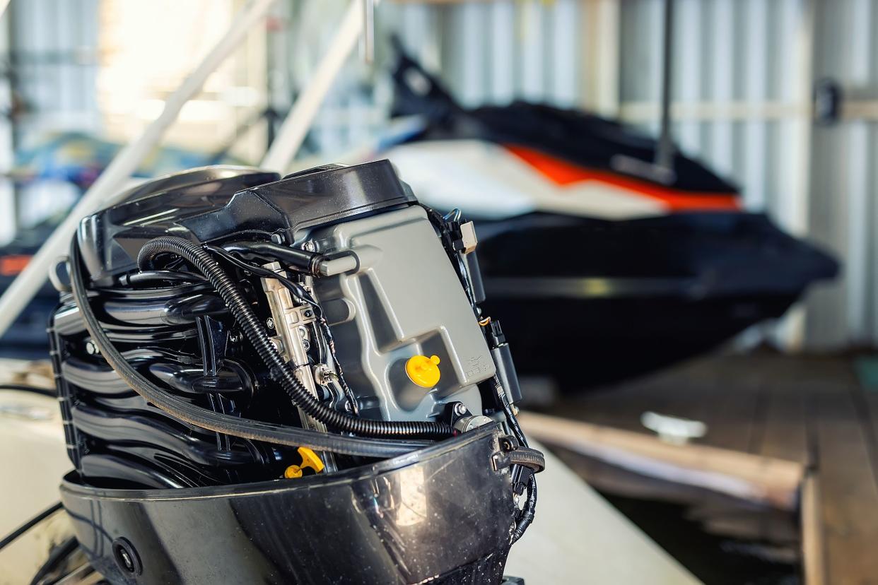 repairing inflatable motorboat engine at boat garage