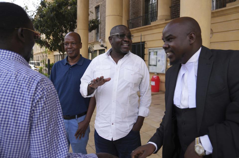 Kenya's former presidential candidate Ekuru Aukot, center, gestures outside the Milimani court in the capital Nairobi, Kenya, Friday, Jan. 26, 2024. A Kenyan court on Friday blocked the deployment of 1,000 police officers to Haiti, to help the Caribbean nation deal with gang violence. "A declaration is issued that the National Security Council has no mandate to deploy the National Police Service," Justice Chacha ruled. (AP Photo/Brian Inganga)