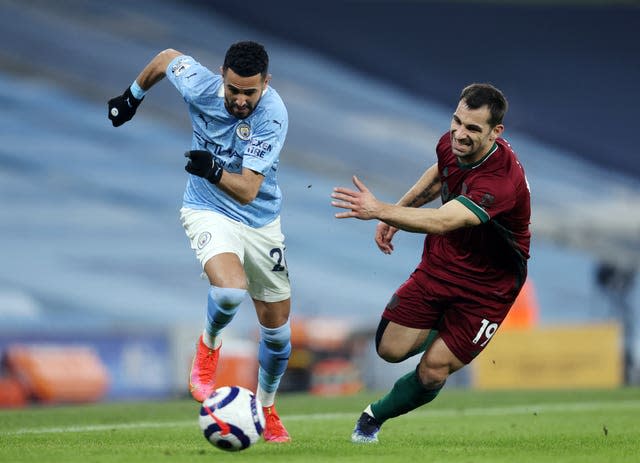 Guardiola has hailed the form of Riyad Mahrez (left)