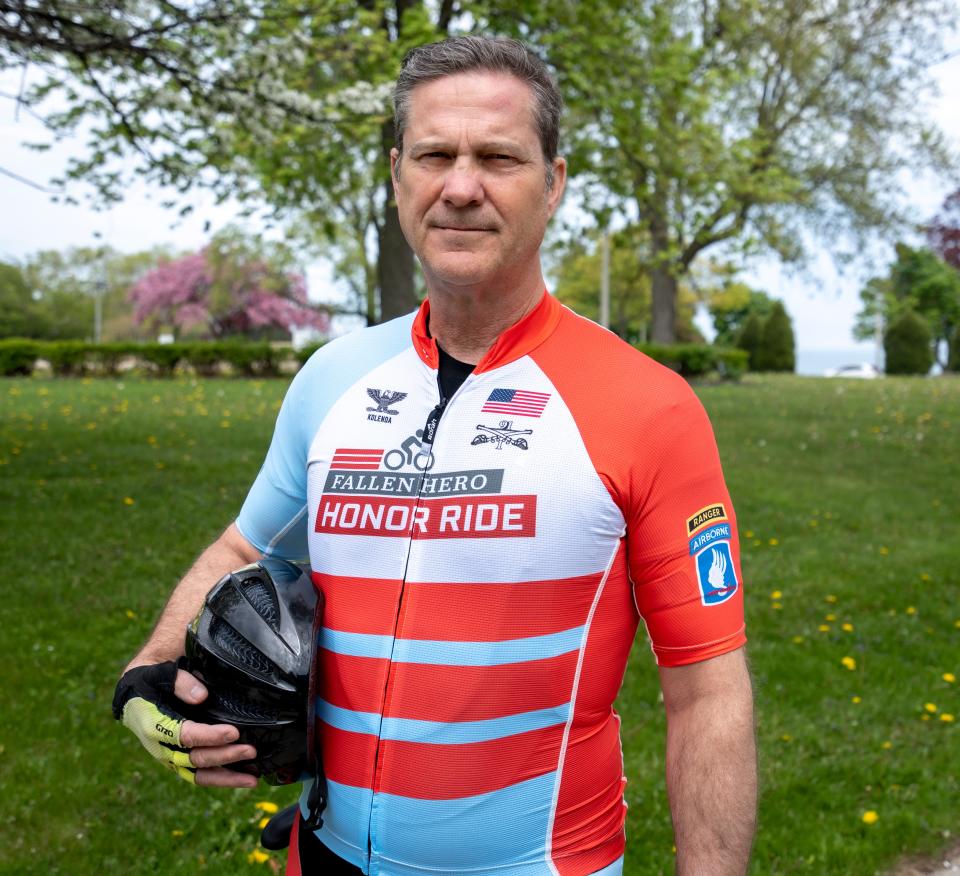Retired U.S. Army Col. Chris Kolenda poses for a photo on on Tuesday, May 24, 2022 in Milwaukee, Wis. He is training for a 1,700-mile cycling tour to visit the grave sites of six members of his military unit who were killed in action in Afghanistan. He is also raising funds for the Saber Six Foundation that helps the units veterans.