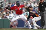 Boston Red Sox's Jackie Bradley Jr. gets back to first safely on a pickoff attempt to Houston Astros first baseman Nick Tanielu during a spring training baseball game, Thursday, March 5, 2020, in Fort Myers, Fla. (AP Photo/Elise Amendola)