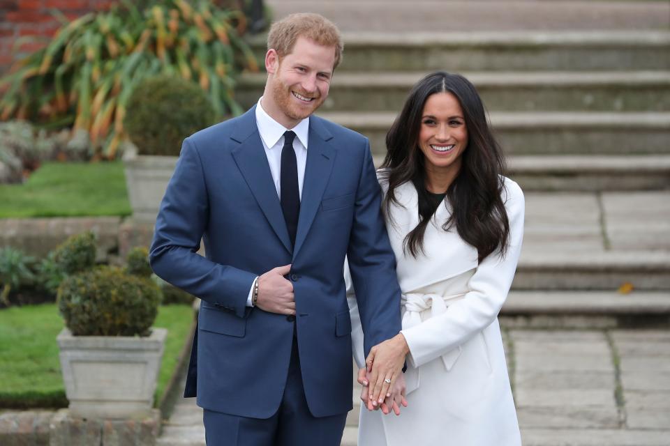 Britain's Prince Harry and his fiancée US actress Meghan Markle pose for a photograph in the Sunken Garden at Kensington Palace in west London on November 27, 2017, following the announcement of their engagement.
Britain's Prince Harry will marry his US actress girlfriend Meghan Markle early next year after the couple became engaged earlier this month, Clarence House announced on Monday. / AFP PHOTO / Daniel LEAL-OLIVAS        (Photo credit should read DANIEL LEAL-OLIVAS/AFP via Getty Images)