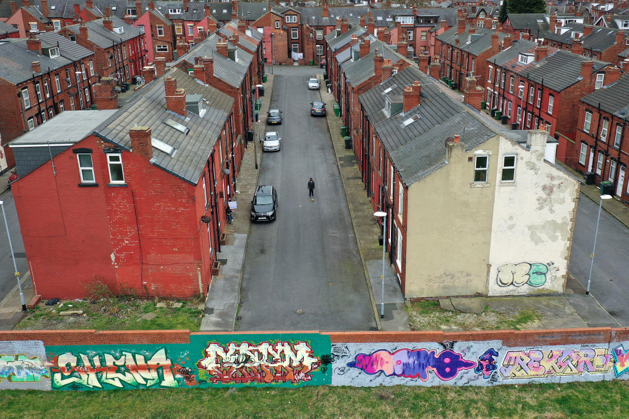 LEEDS, UNITED KINGDOM - MARCH 19: A boy plays football in the street next to traditional back to back homes in Beeston on March 19, 2021 in Leeds, United Kingdom. (Photo by Christopher Furlong/Getty Images)