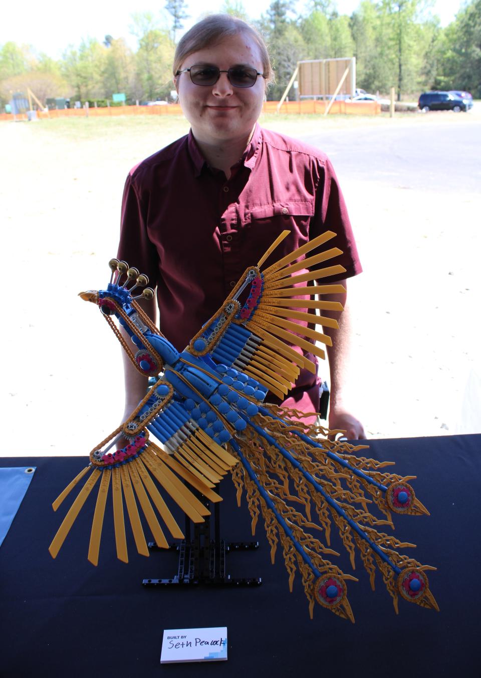 Seth Peacock strikes a pose with his LEGO peacock at the LEGO Manufacturing Richmond groundbreaking ceremony in Chester, Va. on April 13, 2023.