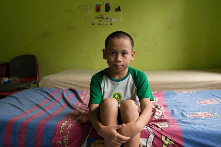 This picture taken on October 31, 2013, shows an Indonesian young boy called Fazri, attending Italian violinist Sara Michieletto's class at a shelter for less fortunate children in Bekasi in the outskirt city of Jakarta