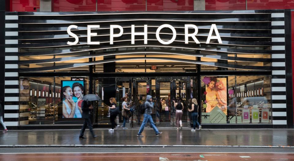 A Sephora storefront with people walking along a sidewalk