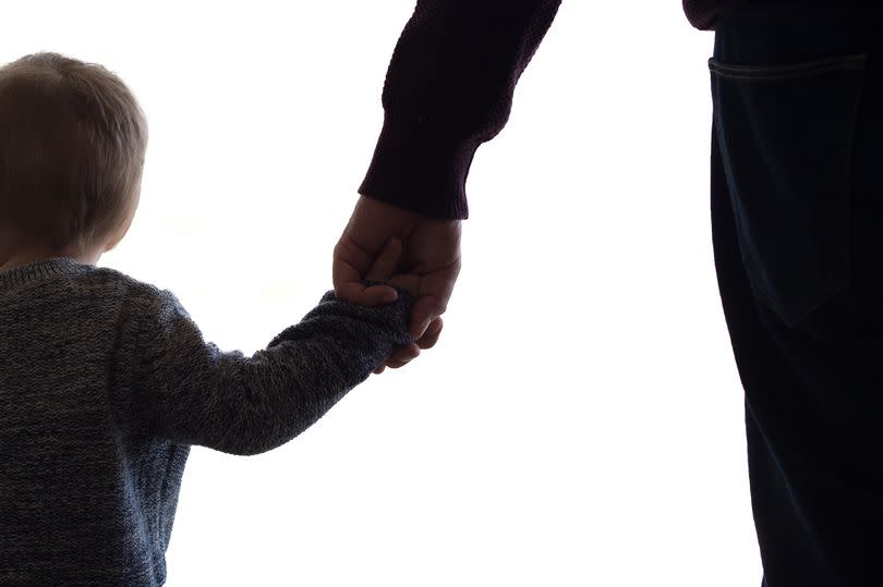 Father and son enjoying and showing their love holding hands. The image is on white background for easy editing