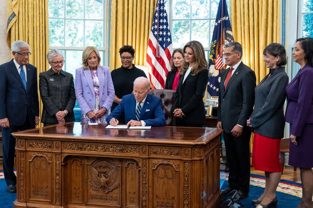 <p>Official White House Photo by Adam Schultz</p> President Biden signs a memorandum on women's health research in the Oval Office on Nov. 13, 2023. OMB Director Shalanda Young stands just behind him, on the left