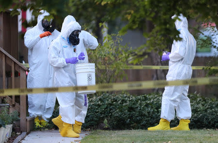 FBI and law enforcement officers in hazmat suites prepare to enter a house, which FBI says was investigating "potentially hazardous chemicals" in Logan, Utah, U.S., October 3, 2018. REUTERS/George Frey