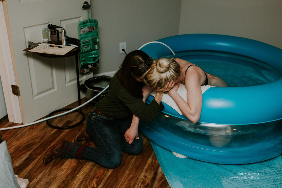 "You can see this midwife's birth supplies in the background, but her tools were down for this moment. Here, her focus was providing physical and emotional support."