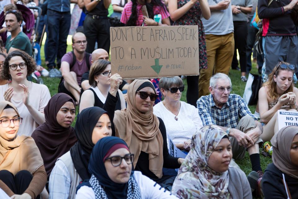 A Muslim woman holds a sign&nbsp;during a protest against President Donald Trump and his policies in Melbourne, Australia, Feb. 3, 2017.