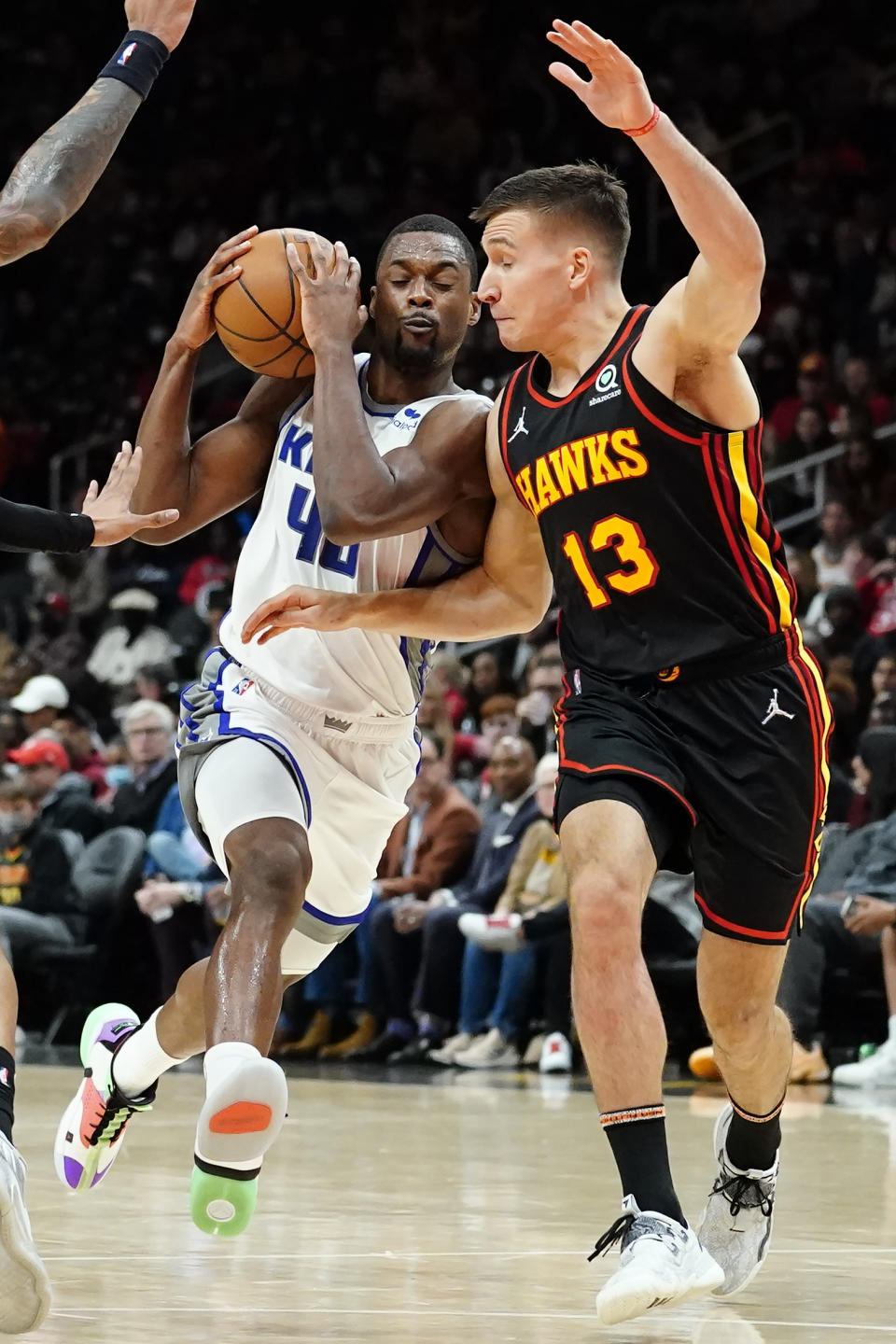 Sacramento Kings forward Harrison Barnes (40) drives against Atlanta Hawks guard Bogdan Bogdanovic (13) in the second half of an NBA basketball game Wednesday, Jan. 26, 2022, in Atlanta. (AP Photo/John Bazemore)