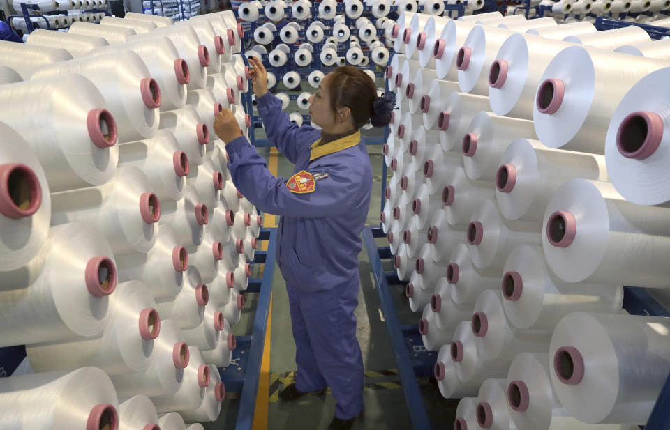 An employee works in a chemical fiber plant in Nantong in eastern China's Jiangsu Province, Friday, Jan. 17, 2020. China's economic growth sank to a new multi-decade low in 2019 as Beijing fought a tariff war with Washington, but forecasters said a U.S.-Chinese trade truce might help to revive consumer and business activity. (Chinatopix via AP)