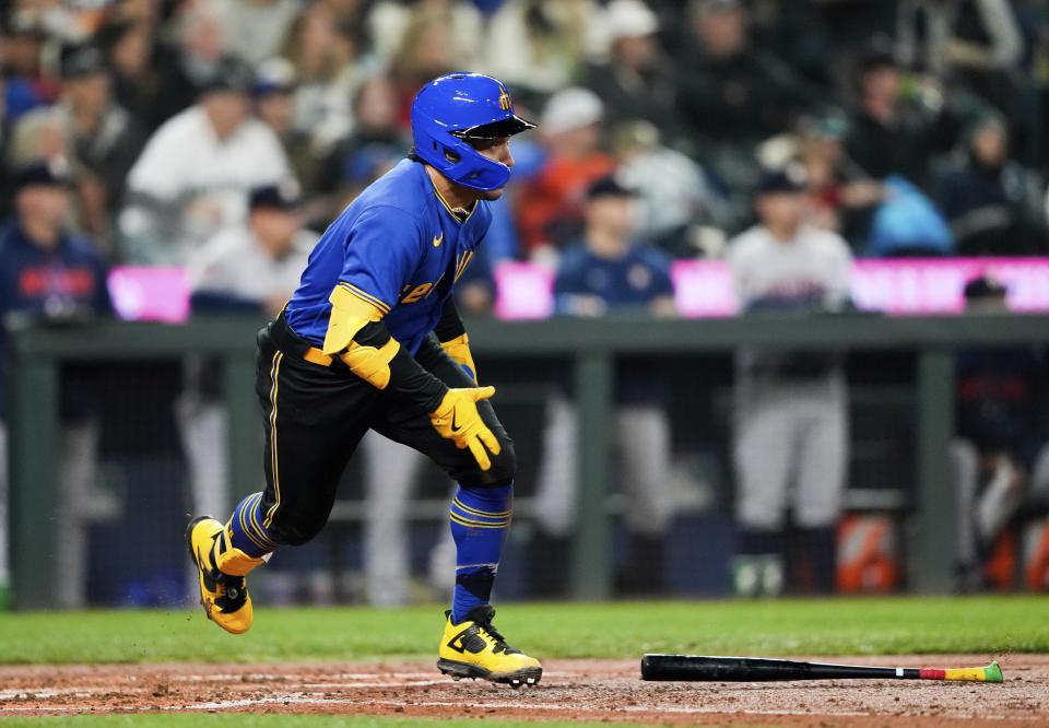 Seattle Mariners' Kolten Wong begins to run the bases after hitting a three-run double against the Houston Astros during the fifth inning of a baseball game Friday, May 5, 2023, in Seattle. (AP Photo/Lindsey Wasson)