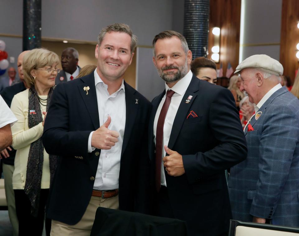 Michael Waltz and Cory Mills give a thumbs up during a Republican watch party in Daytona Beach, Tuesday, August 23, 2022.