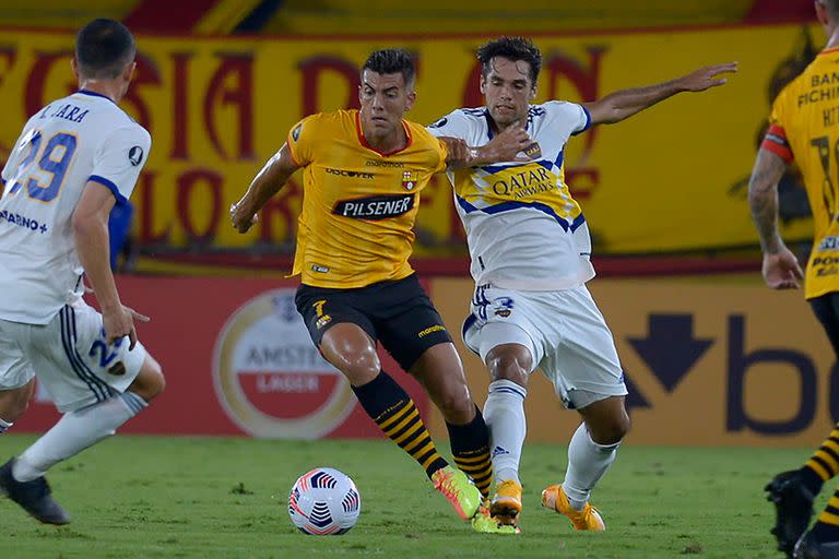 Michael Hoyos y Emmanuel Mas disputan la pelota durante el partido entre Boca Juniors y Barcelona S.C. de Ecuador.