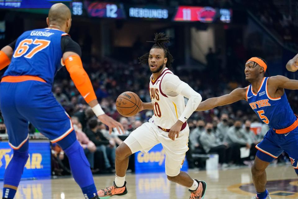 Cavaliers guard Darius Garland (10) drives against New York Knicks forward Taj Gibson (67) and guard Immanuel Quickley (5) in the first half of the Cavs' 95-93 win Monday night at Rocket Mortgage FieldHouse. [Tony Dejak/Associated Press]