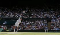 Milos Raonic of Canada serves during his men's singles semi-final tennis match against Roger Federer of Switzerland at the Wimbledon Tennis Championships, in London July 4, 2014. REUTERS/Stefan Wermuth (BRITAIN - Tags: SPORT TENNIS)