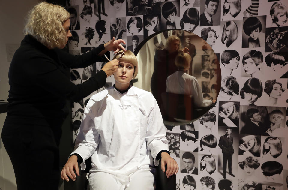 A model receives a signature 1960s style from a Sassoon stylist