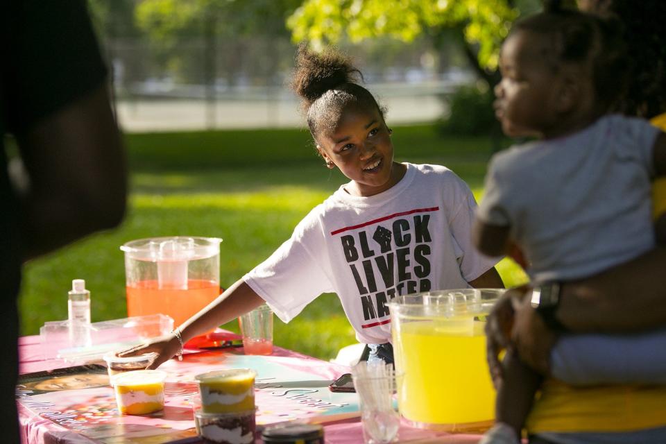 Bre'yonna Woodfolk, 10, of Bookas Sweet Boutique, sells lemonade and desserts during a 2020 Juneteenth celebration at Goodale Park.