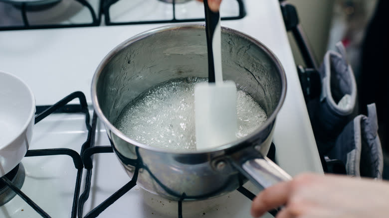 person stirring sugar mixture