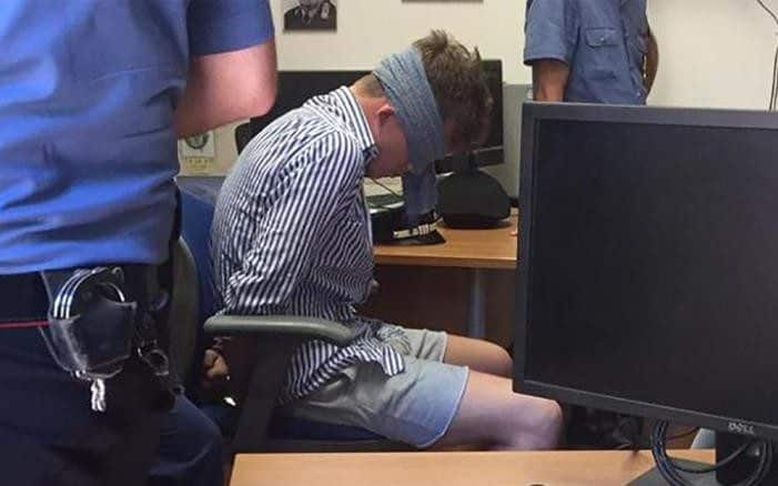 One of two Americans arrested over the killing of an Italian police officer in Rome is pictured blindfolded in a police station. Photo leaked to Corriere della Sera 