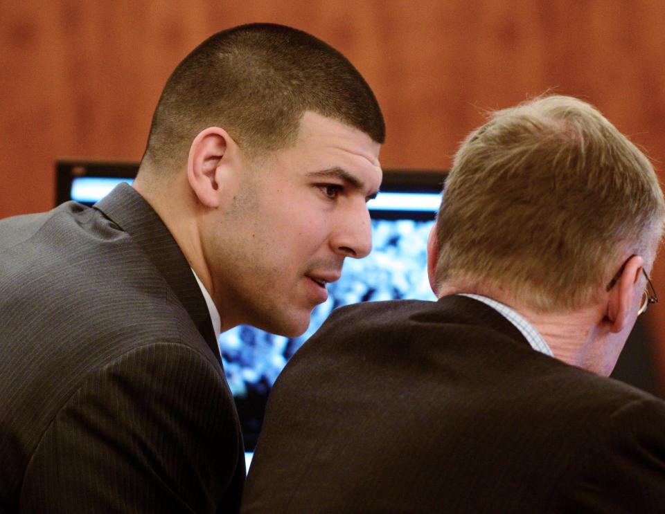 Former New England Patriots football player Aaron Hernandez sits with his attorney Charles Rankin during his murder trial at Bristol County Superior Court in Fall River, Massachusetts February 11, 2015. REUTERS/Ted Fitzgerald/Pool (UNITED STATES - Tags: CRIME LAW SPORT FOOTBALL)