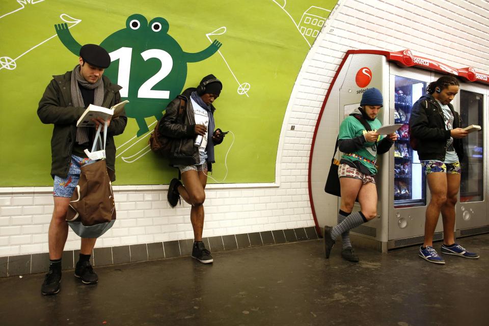 Passengers without their pants wait for a train during the "No Pants Subway Ride" event at a subway station in Paris