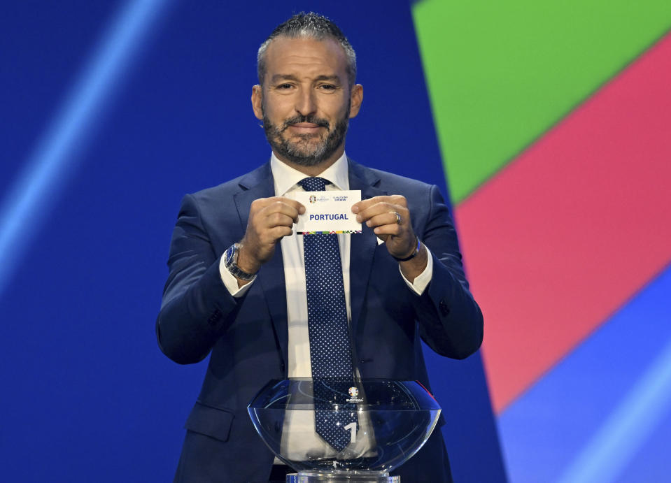 Gianluca Zambrotta, former soccer player and soccer official, holds the lot of Portugal during the draw for the groups to qualify for the 2024 European soccer championship in Frankfurt, Germany, Sunday, Oct.9, 2022. (Arne Dedert/dpa via AP)