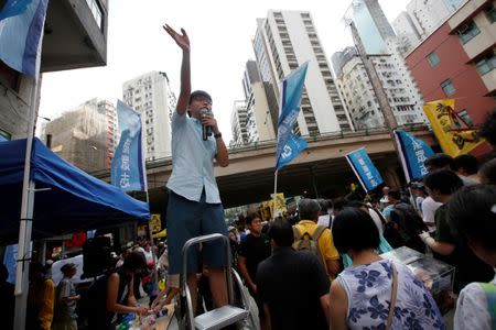 Pro-democracy activist Joshua Wong wave to supporters during a protest march in Hong Kong, China July 1, 2018, the day marking the 21st anniversary of the city's handover to Chinese sovereignty from British rule. REUTERS/Bobby Yip