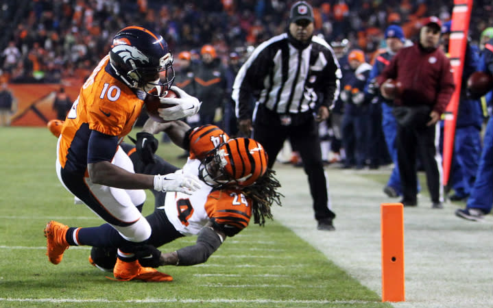 Dec 28, 2015; Denver, CO, USA; Denver Broncos wide receiver Emmanuel Sanders (10) escapes a tackle from Cincinnati Bengals cornerback Adam Jones (24) to score a touchdown during the second half at Sports Authority Field at Mile High. Mandatory Credit: Chris Humphreys-USA TODAY Sports