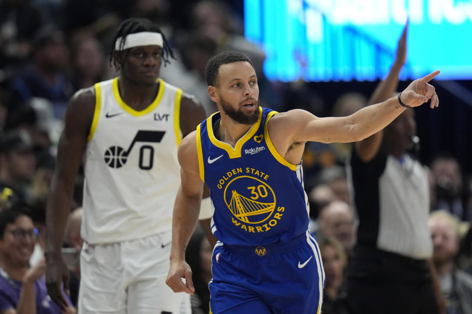 Golden State Warriors guard Stephen Curry (30) celebrates after scoring against the Utah Jazz during the first half of an NBA basketball game Thursday, Feb. 15, 2024, in Salt Lake City. (AP Photo/Rick Bowmer)