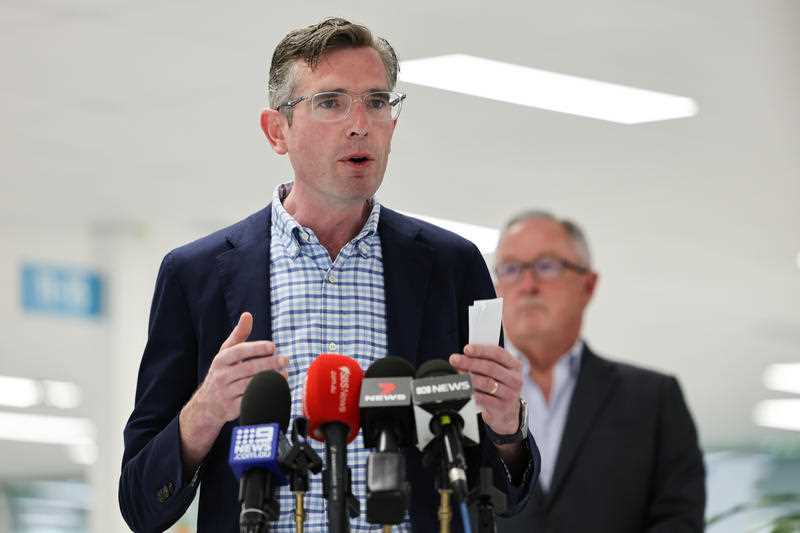 NSW Premier Dominic Perrottet (left) speaks to the media during a press conference with Health Minister Brad Hazzard (right) at the Sydney Olympic Park Vaccination Hub in Sydney.