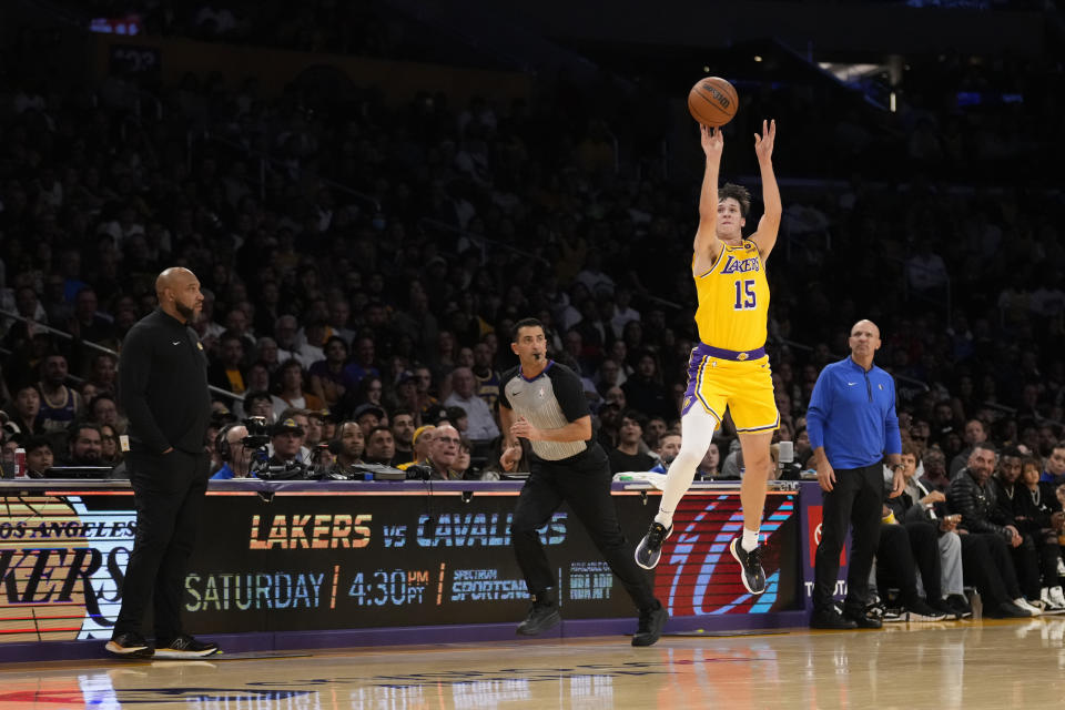 Los Angeles Lakers guard Austin Reaves (15) shoots as time expires at the end of the first half of the team's NBA basketball game against the Dallas Mavericks on Wednesday, Nov. 22, 2023, in Los Angeles. The score was nullified after a video replay. (AP Photo/Marcio Jose Sanchez)