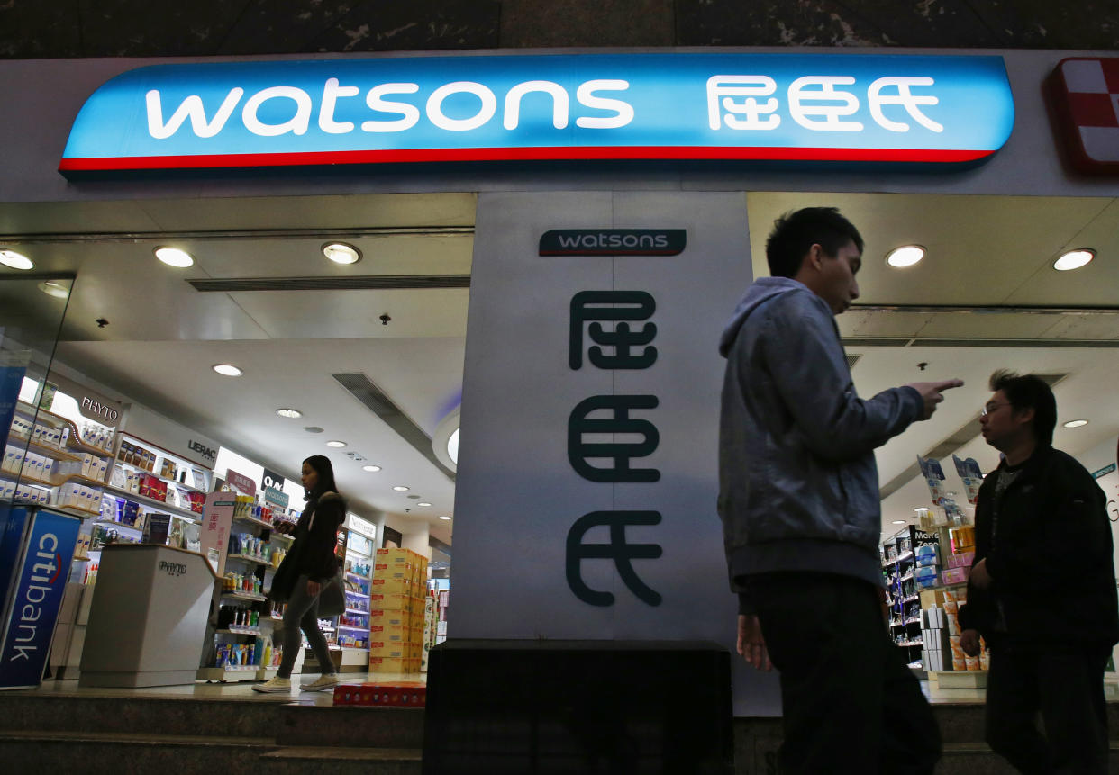 People walk past a Wastons retail store in Hong Kong. (Photo:REUTERS/Bobby Yip)