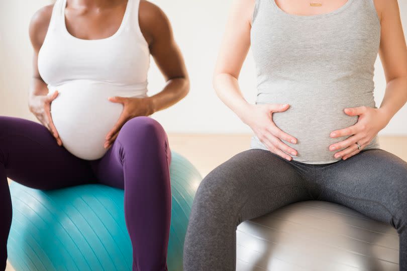 Pregnant women sitting on a birthing ball