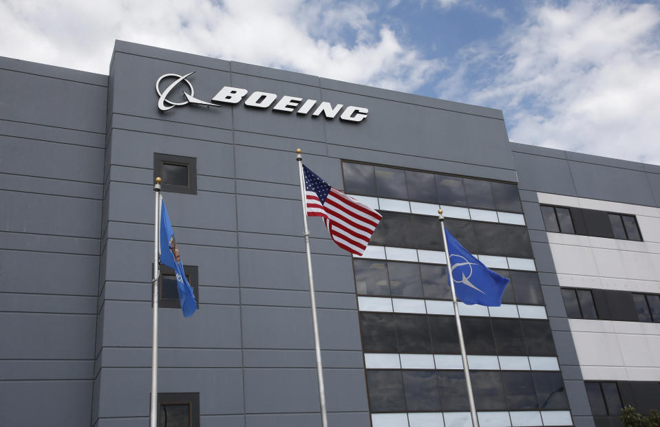 FILE - In this May 14, 2019, file photo flags fly outside the main building of The Boeing Company's Oklahoma City facility in Oklahoma City. Boeing Co. reports financial earns on Wednesday, Oct. 23. (AP Photo/Sue Ogrocki, File)