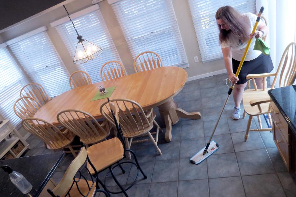 LBI Cleaning owner Erin Golden sweeps the floor in a Surf City home her crew was cleaning Thursday, June 16, 2022.  The company now has six employees, but it needs 30 for the summer season.