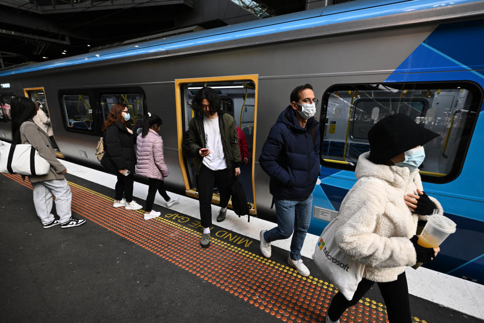 Passengers wearing face masks at Southern Cross Station in Melbourne. Source: AAP