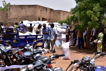 Displaced people receive humanitarian aid in the city of Kaya, Burkina Faso May 16, 2019. REUTERS/Anne Mimault