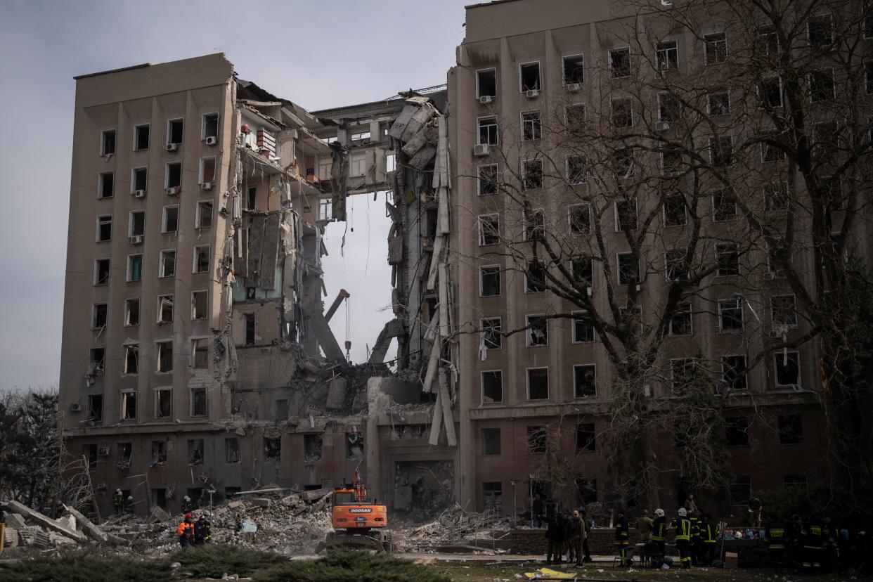 Emergency personnel work at the site of the regional government headquarters of Mykolaiv, Ukraine, following a deadly Russian attack.