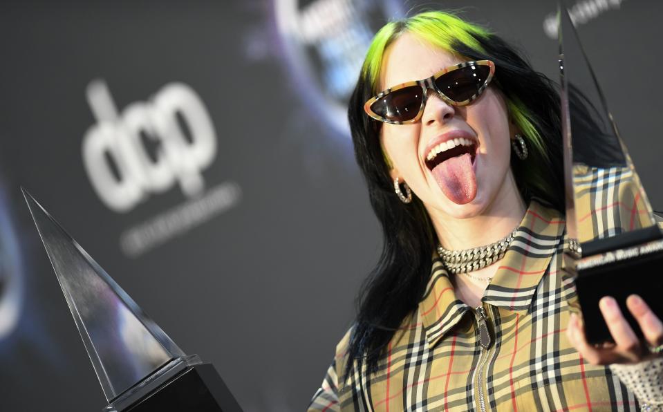 US singer/songwriter Billie Eilish poses with her awards for New Artist of the Year and Alternative Artist in the press room during the 2019 American Music Awards at the Microsoft theatre on November 24, 2019 in Los Angeles. (Photo by Valerie MACON / AFP) (Photo by VALERIE MACON/AFP via Getty Images)